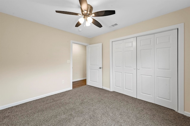 unfurnished bedroom featuring carpet, a closet, and ceiling fan