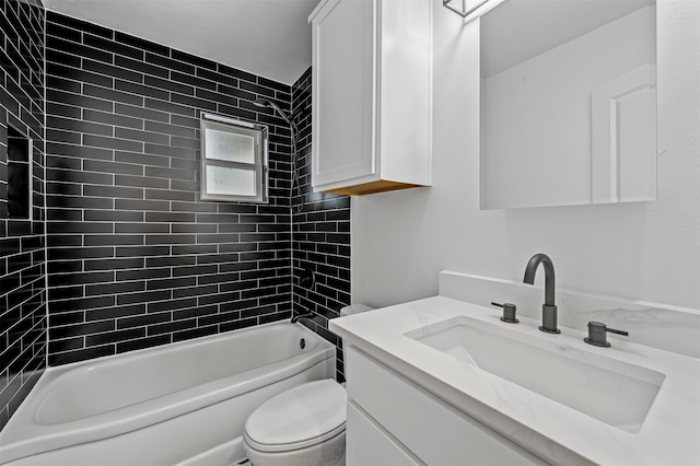 full bathroom featuring vanity, tiled shower / bath combo, and toilet