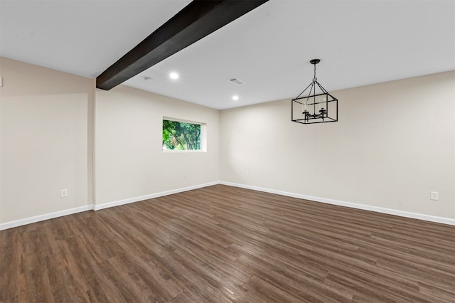 empty room with beamed ceiling, a notable chandelier, and dark wood-type flooring