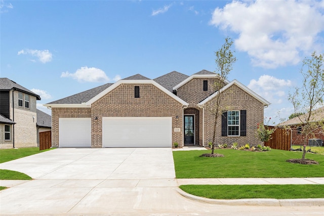 view of front of home featuring a garage and a front yard