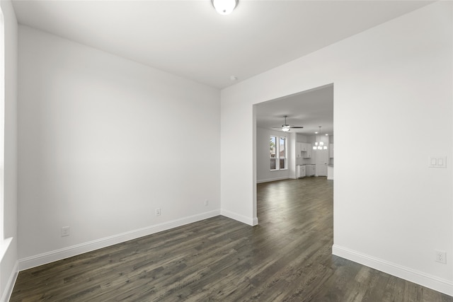 spare room with dark hardwood / wood-style floors and ceiling fan