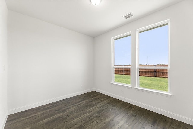 empty room with dark wood-type flooring