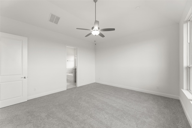 unfurnished room with a healthy amount of sunlight, light colored carpet, and ceiling fan