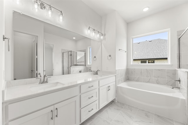 bathroom featuring vanity and separate shower and tub