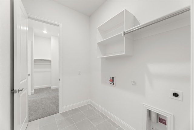 clothes washing area featuring hookup for an electric dryer, hookup for a washing machine, gas dryer hookup, and light tile patterned floors