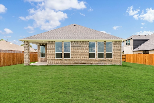 rear view of house featuring a patio area and a lawn