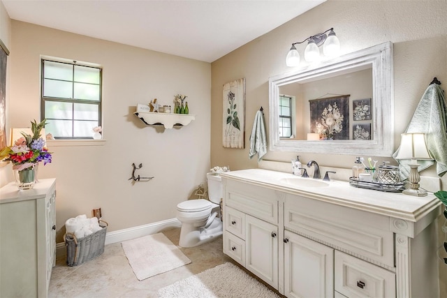 bathroom with vanity, toilet, and tile patterned flooring