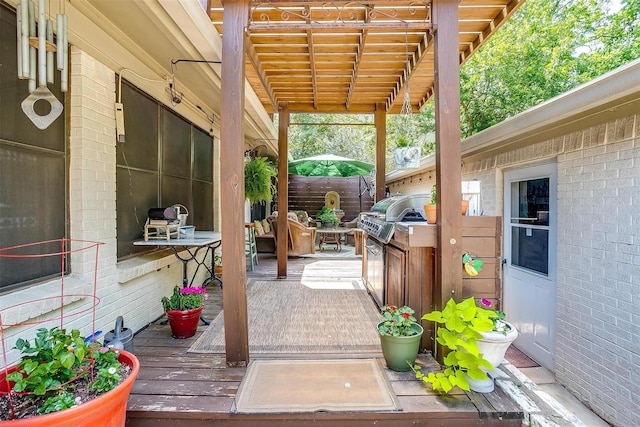 wooden terrace with a pergola and area for grilling