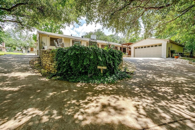 view of front of home featuring concrete driveway and a garage