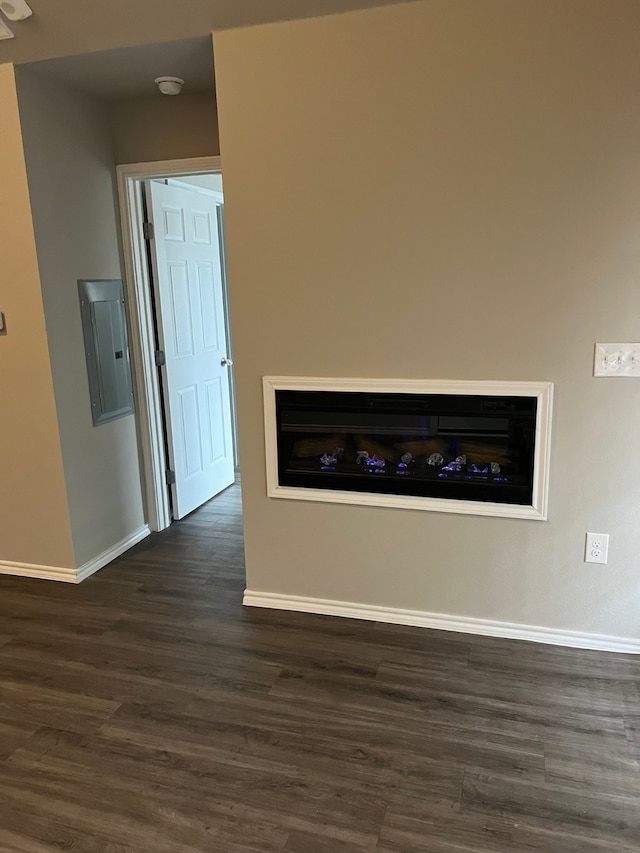 interior space with electric panel and dark wood-type flooring