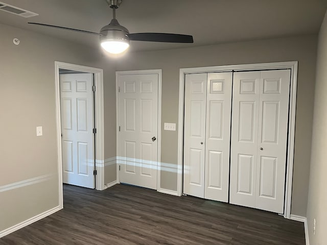 unfurnished bedroom featuring dark hardwood / wood-style floors and ceiling fan