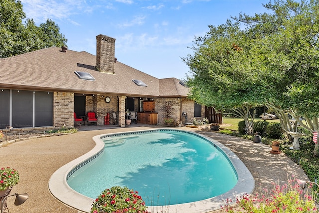 view of swimming pool with a patio area