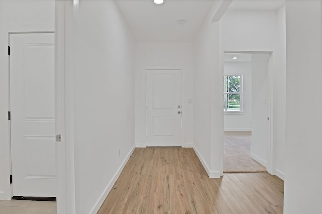 corridor featuring light colored carpet