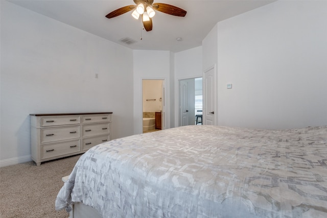 carpeted bedroom featuring ceiling fan and ensuite bath