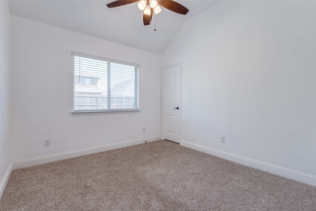 carpeted empty room featuring ceiling fan and vaulted ceiling