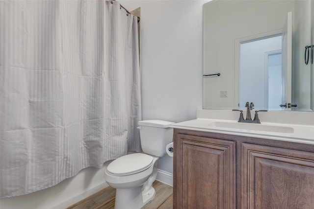 full bathroom with hardwood / wood-style flooring, toilet, shower / tub combo with curtain, and vanity