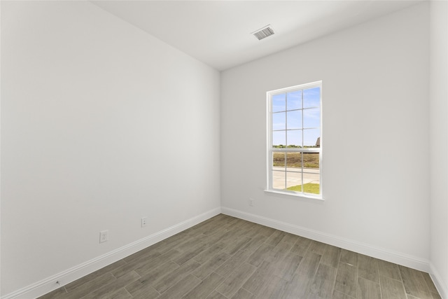 unfurnished room with wood-type flooring