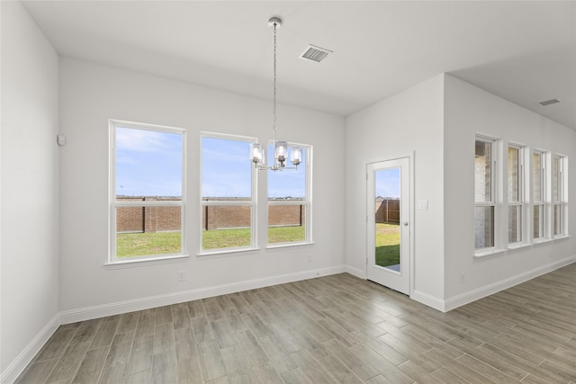 unfurnished dining area featuring light hardwood / wood-style floors and plenty of natural light