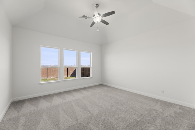 carpeted spare room featuring ceiling fan and lofted ceiling