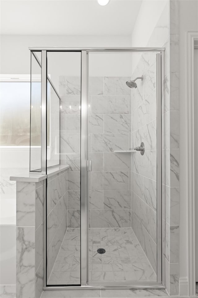 bathroom with a shower with shower door