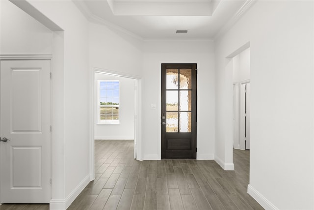 foyer featuring ornamental molding and hardwood / wood-style flooring