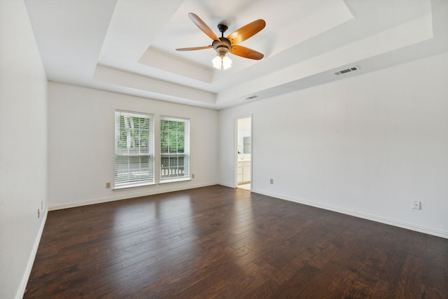 spare room featuring hardwood / wood-style flooring, ceiling fan, and a tray ceiling