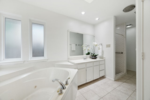 bathroom with tile patterned flooring, vanity, and a tile shower