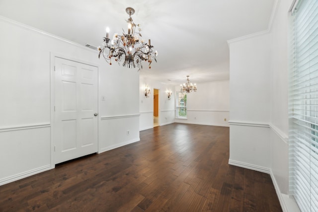 unfurnished dining area with an inviting chandelier, crown molding, and dark hardwood / wood-style floors