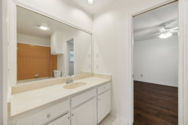 bathroom with vanity, toilet, hardwood / wood-style flooring, and ceiling fan