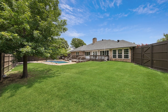 view of yard with a pool side deck