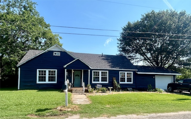 view of front of house with a garage and a front yard