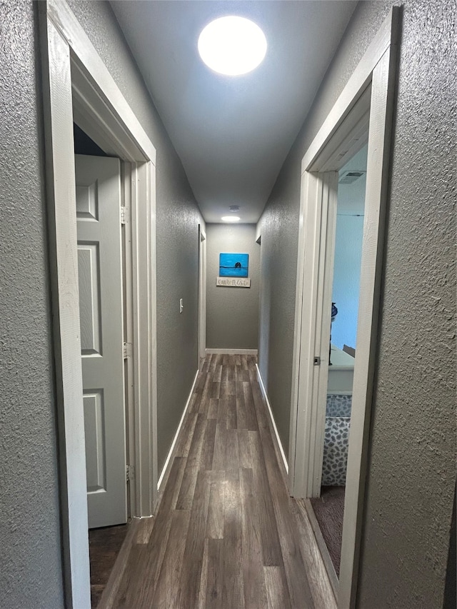 hall with hardwood / wood-style floors