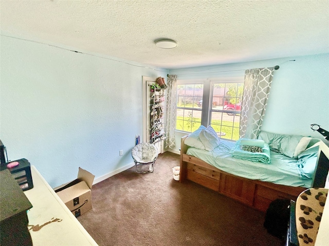 carpeted bedroom featuring a textured ceiling