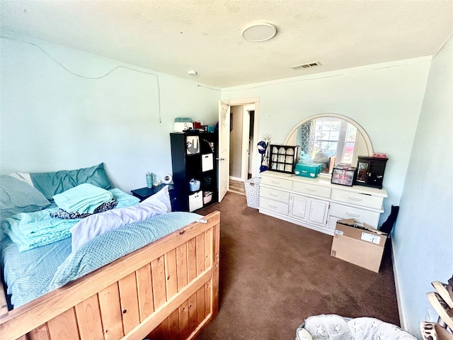 carpeted bedroom with black refrigerator