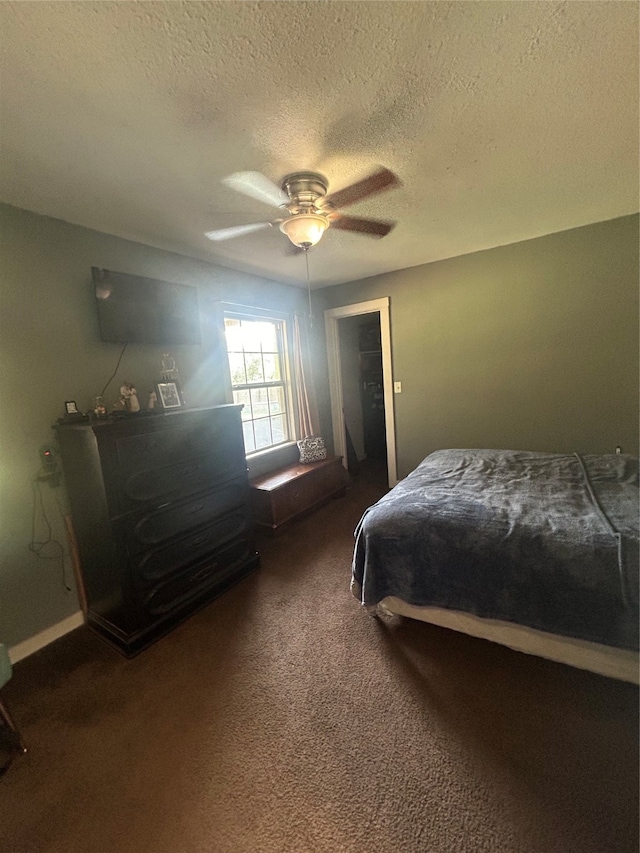 carpeted bedroom with a textured ceiling and ceiling fan