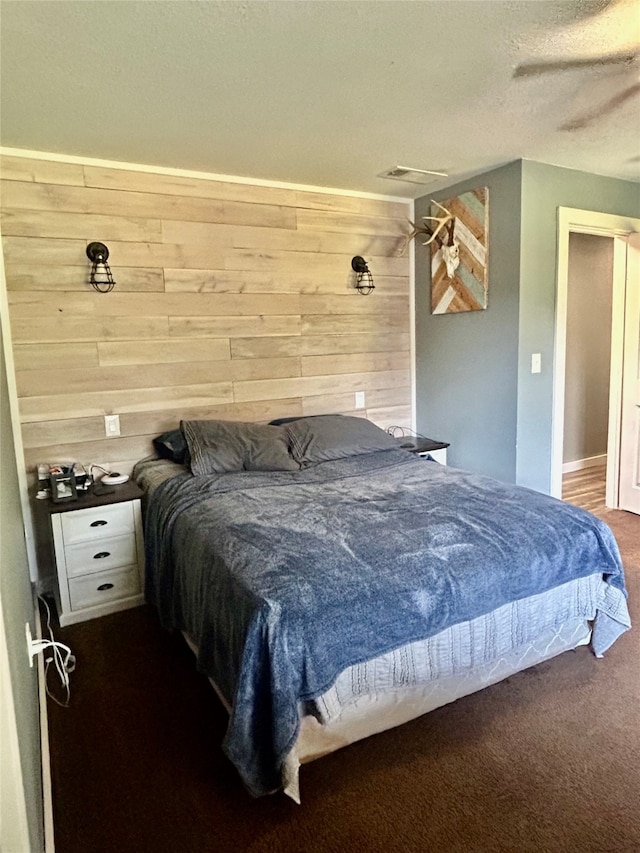 carpeted bedroom with a textured ceiling and ceiling fan