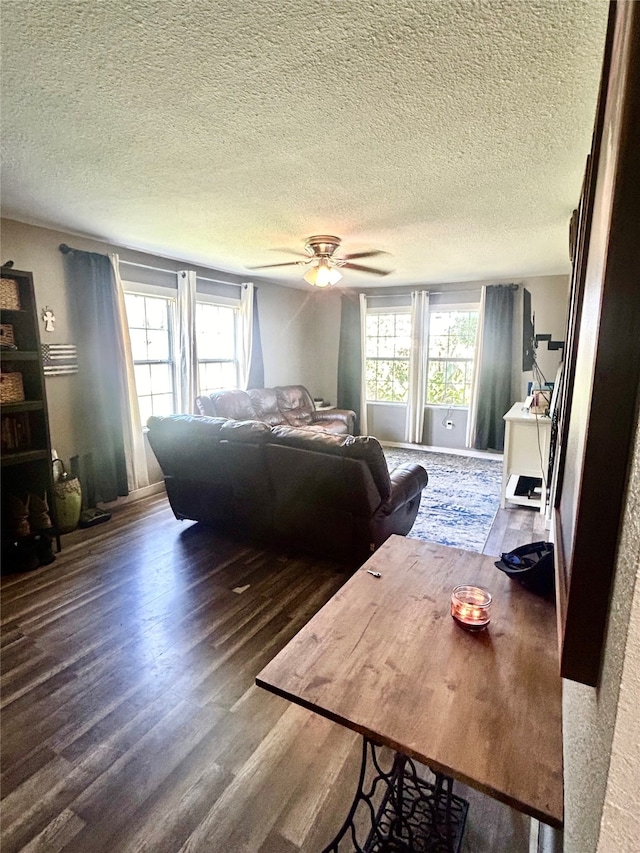 bedroom with a textured ceiling, ceiling fan, and wood-type flooring