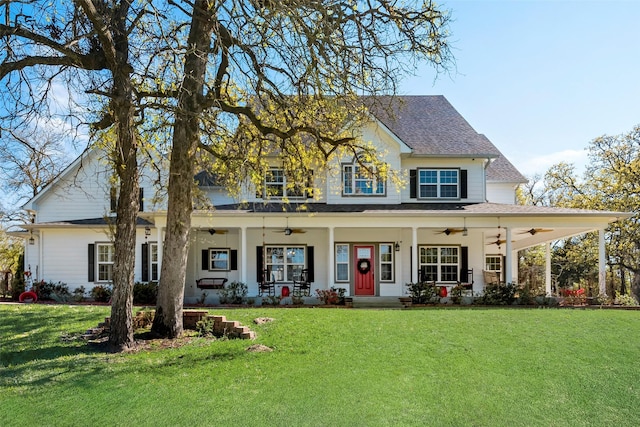 view of front of home with a front yard, covered porch, and ceiling fan