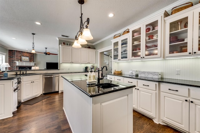 kitchen featuring a kitchen island, decorative light fixtures, ceiling fan, stainless steel dishwasher, and crown molding