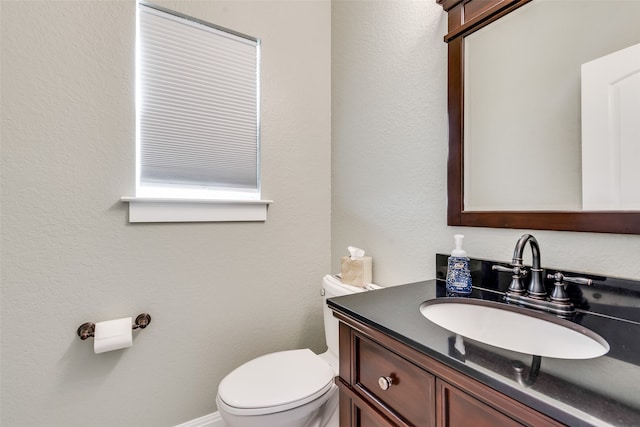 bathroom featuring toilet and vanity