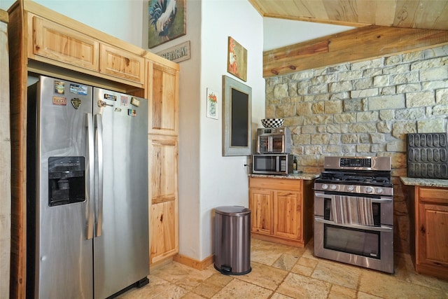 kitchen featuring lofted ceiling, wood ceiling, appliances with stainless steel finishes, light tile patterned flooring, and light stone counters