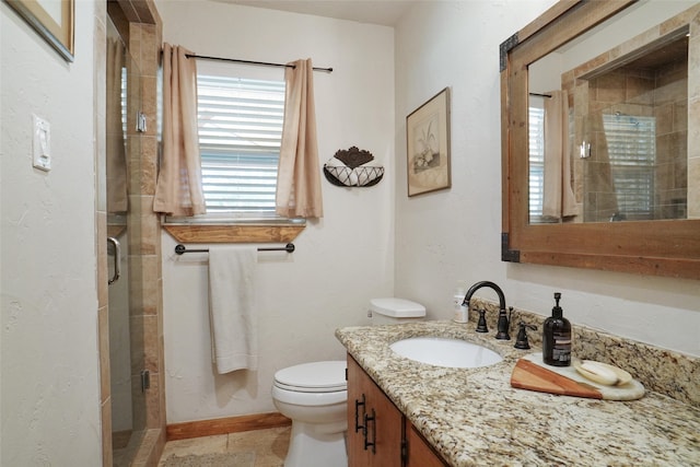 bathroom with tile patterned floors, vanity, walk in shower, and toilet