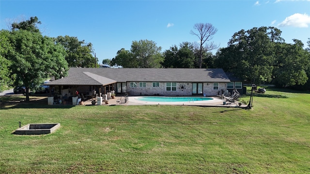 back of house featuring a patio area and a lawn