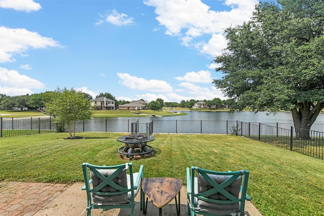 view of yard with a patio, a water view, and an outdoor fire pit