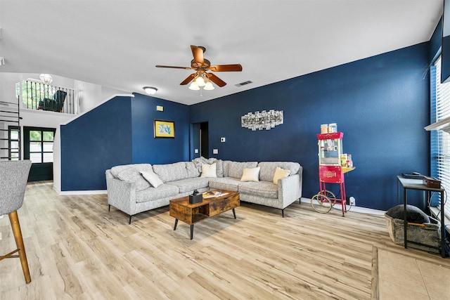 living room with ceiling fan and light hardwood / wood-style flooring