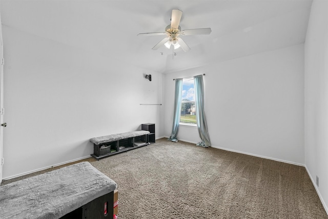 carpeted spare room featuring ceiling fan