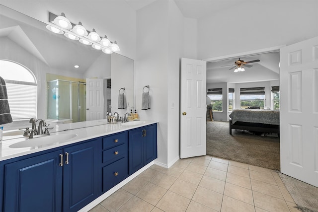 bathroom featuring vaulted ceiling, walk in shower, tile patterned floors, ceiling fan, and vanity