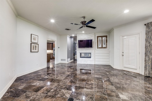 living room with crown molding, a fireplace, and ceiling fan