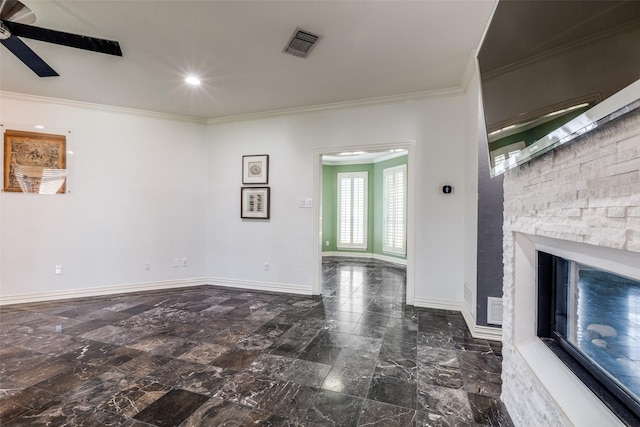 unfurnished living room featuring ornamental molding, ceiling fan, and a fireplace