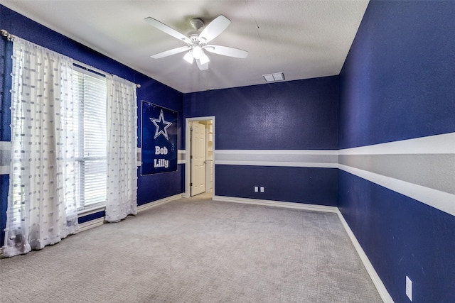 carpeted empty room with ceiling fan